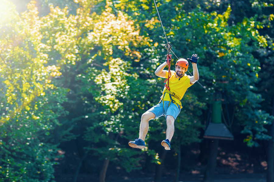 Happy Men Boy Male Gliding Climbing Down In Extreme Road Trolley